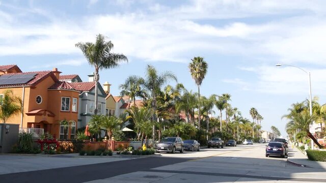 California typical suburban street, tropical Oceanside USA. Different colorful houses row. Generic american homes, buildings facade, townhouse exterior architecture. Residential district real estate.