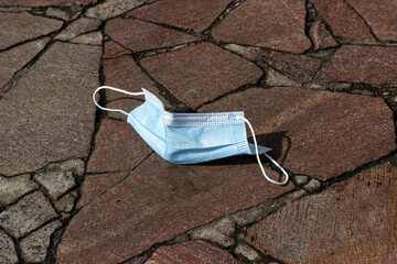 medical mask on the sidewalk in the city