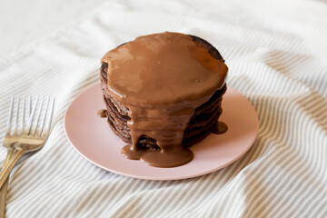 Homemade Chocolate Pancakes on a pink plate, low angle view.