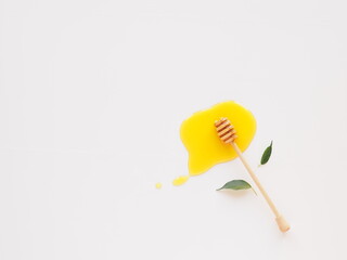 Top view honey dipper with splash of honey and copy space