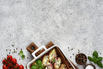 Filled Italian conciglioni. Conciglioni with ricotta baked in tomato sauce with parmesan on a concrete background.Baked pasta with ricotta.