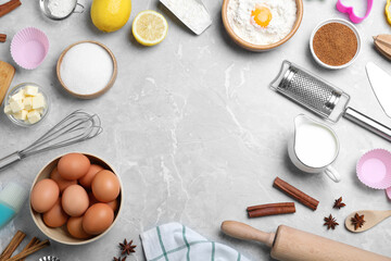 Frame of cooking utensils and ingredients on light marble table, flat lay. Space for text