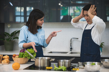 couple person cooking food in kitchen at home, woman and man are happy together with healthy meal food from vegetable, wife and husband in love lifestyle concept