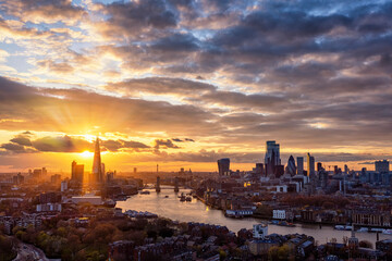 Fototapeta na wymiar The urban skyline of London, United Kingdom, with Tower Bridge, Thames river and City district during a colorful sunset