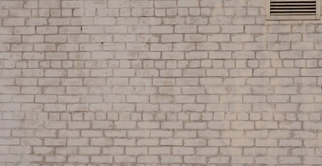 White brick wall and ventilation at the top right. Horizontal.