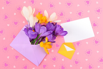 crocuses in an envelope on a background of hearts