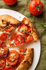Galette with fresh tomatoes, herbs and cheese, open pie