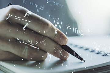 Creative scientific formula concept with man hand writing in notebook on background. Multiexposure