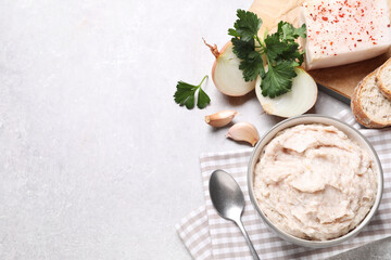 Delicious lard spread in bowl on light table, flat lay. Space for text