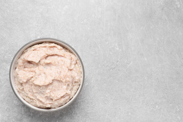 Delicious lard spread in bowl on light table, top view. Space for text