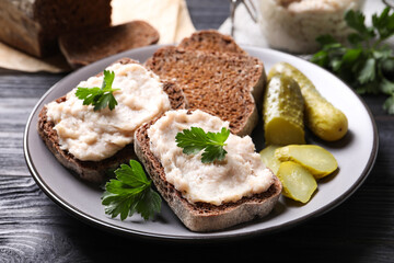Delicious sandwiches with lard spread on black wooden table, closeup
