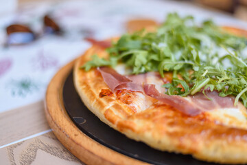 Part of small supreme delicious fast food pizza on the table
