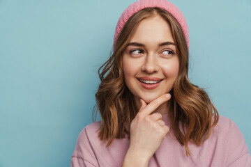 Young white woman smiling and touching her chin