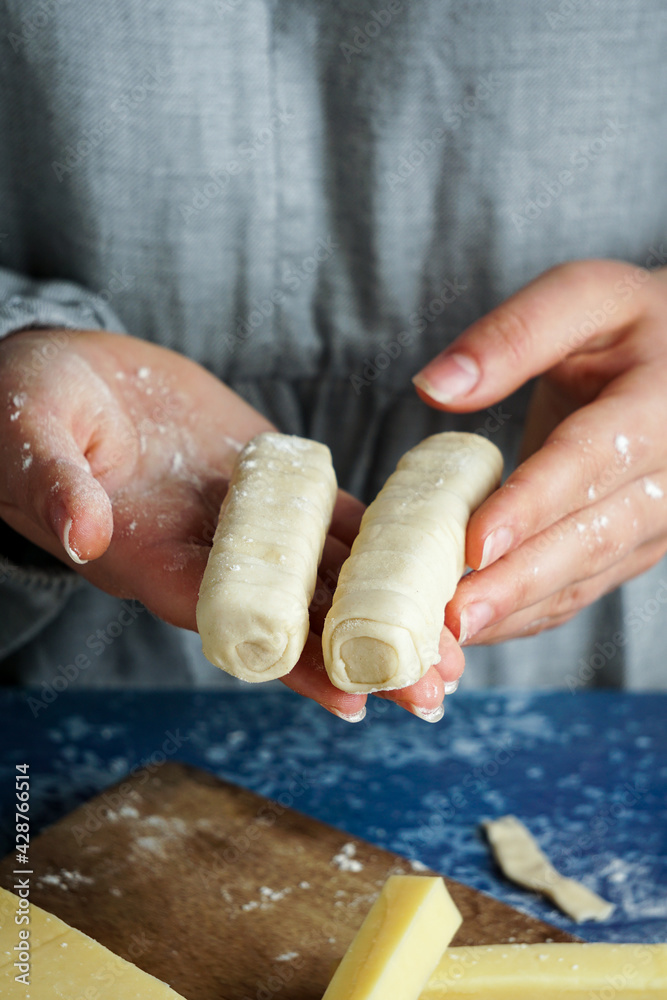 Wall mural tequeno typical snack of venezuelan food - woman chef making tequeños or cheese fingers typical vene