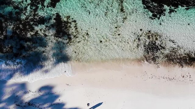Extended Shot Of The Drone Flying Up, Slowly Revealing Hyams Beach And The Turquoise Ocean With The Waves Crashing on The White Sandy Beach