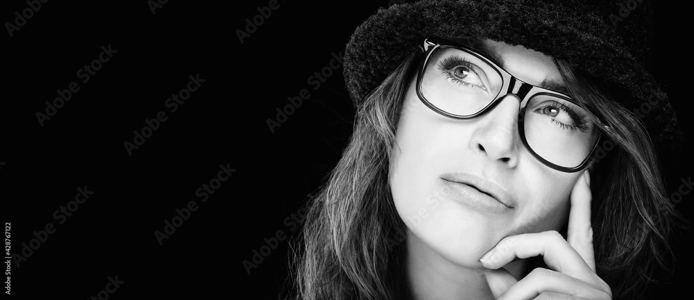 Wall mural Monochrome pensive young woman in eyeglasses. Eye wear and ophthalmology concept