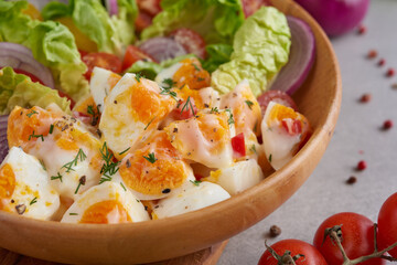 Diet menu. Healthy salad of fresh vegetables - tomatoes, egg, Onion. high angle view of a nutritious vegetable salad with boiled egg slices, served.  Healthy meal concept.