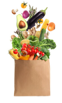 Paper bag with vegetables on white background. Vegetarian food