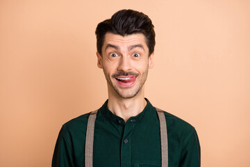 Photo of funny funky young man lick teeth smile good mood weekend isolated on pastel beige color background