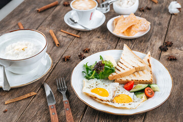 Table served with breakfast of fried eggs and porridge