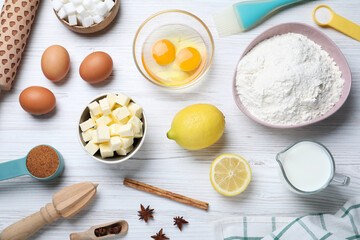 Cooking utensils and ingredients on white wooden table, flat lay