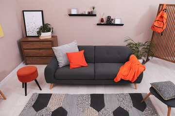 Modern living room interior with comfortable grey sofa