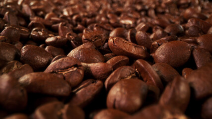Pile of fresh roasted coffee beans with smoke around