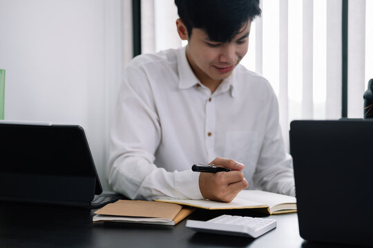 Businessman Holding Pen And Taking Note When Meeting At Office