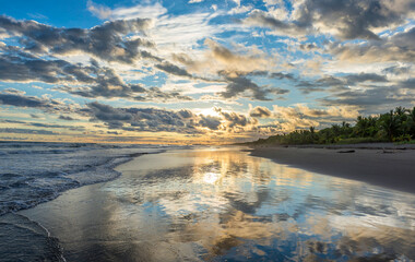 Beautiful sunset sky with clouds on the beach in Matapalo, Costa Rica. Central America. Sky background on sunset. Tropical sea.
