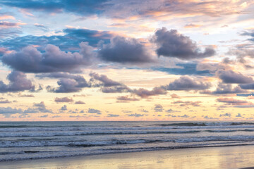 Naklejka na ściany i meble Beautiful sunset sky with clouds on the beach in Matapalo, Costa Rica. Central America. Sky background on sunset. Tropical sea.