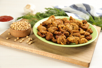 Cooked soy meat in bowl on white wooden table