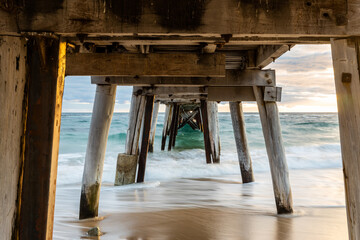 a long exposure under the port noarlunga jetty at sunset in south australia on April 19th 2021