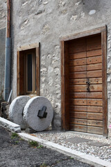 Old millstone in Guardia, rural town in Trentino Alto Adige, Italy