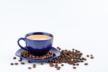 Cup of coffee and coffee beans on a platter on a white background
