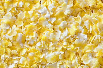 Corn grits groats texture maize meal closeup top view flat closeup background. Concept of healthy...