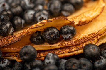 Fresh blueberries and traditional Russian pancakes. Shrovetide week of the end of winter.