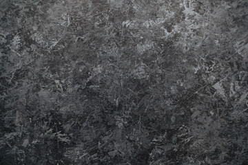 Naklejka premium Dark black stone wall background with textured surface.