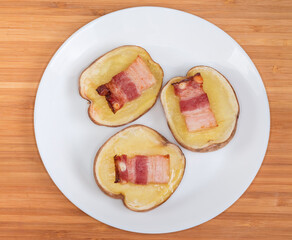 Top view of potato halves baked together with bacon slices