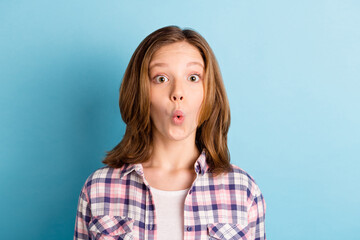 Photo of charming shocked school girl wear plaid shirt big eyes isolated blue color background