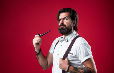 elegant brutal man in formal wear has groomed hair smoking pipe, bad habit