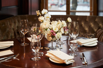 beautifully set table for a wedding by the window in a restaurant