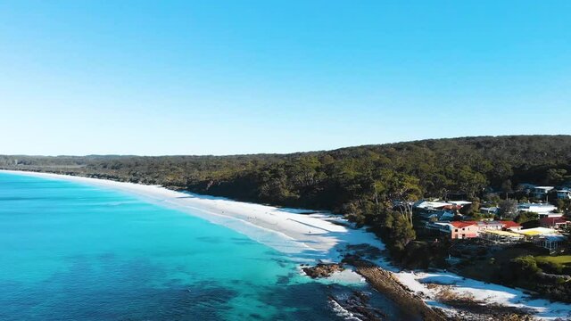 Straight Flying Drone Shot Over Hyams Beach, Showing The Turquoise Ocean With Waves Crashing on the White Sandy Beach