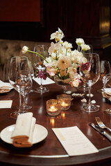 table with transparent glasses and burning candles. romantic dinner