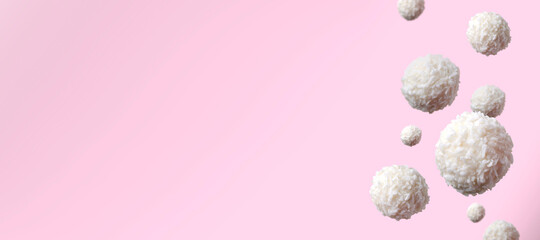 White sweet candy balls against pink background.Empty space