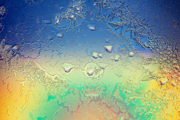 Natural ice texture on the frozen window in colorful light. Gradient color. Christmas background