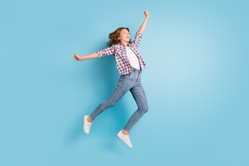 Fototapeta premium Full size photo of young happy cheerful smiling excited girl jumping look copyspace isolated on blue color background