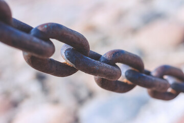 Heavy cast iron chain with rust. Protective fence on the bank of the Neva River in St. Petersburg.