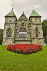 Fototapeta na wymiar Church with red flowers