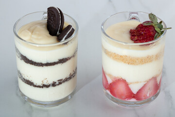 jar of strawberry and oreo pudding magnolia desert over white backdrop