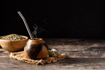 Traditional yerba mate tea on wooden table.Copy space